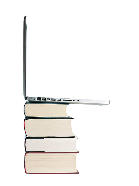 Stacked laptop and books stock photo