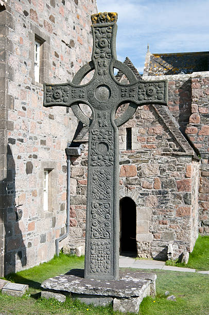 istock Celtic cross standing near old church 152140998