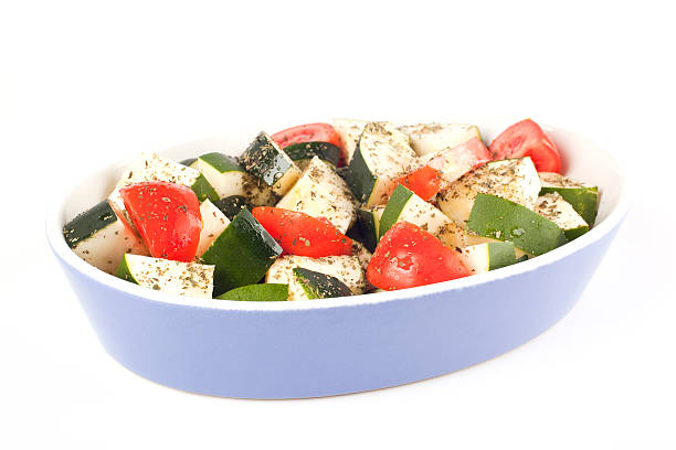 Sliced courgette and tomato ready for roasting stock photo