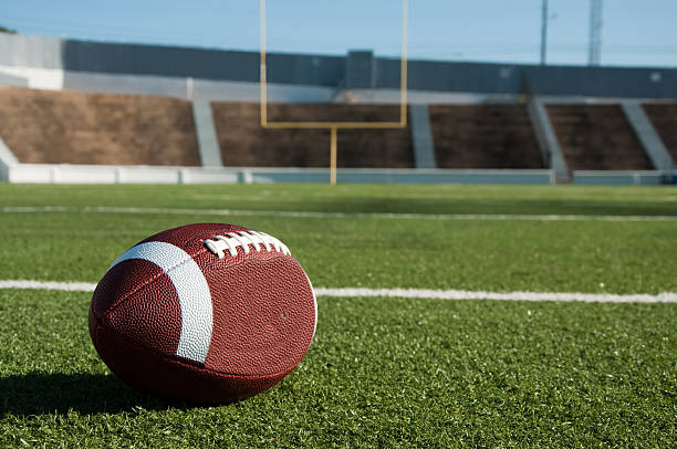 American Football on Field American football on field with goal post in background. goal post stock pictures, royalty-free photos & images