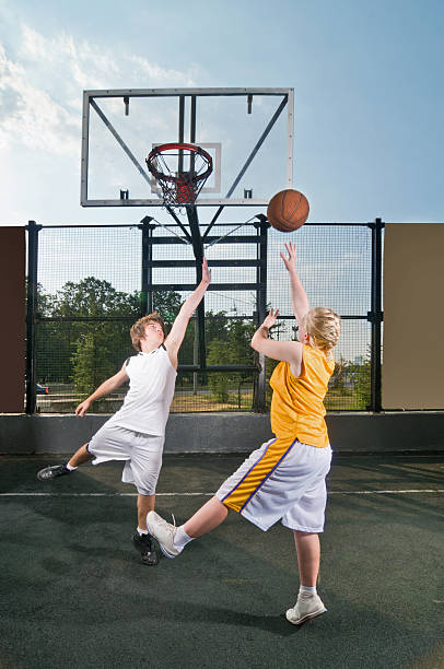 Teenagers playing streetball stock photo