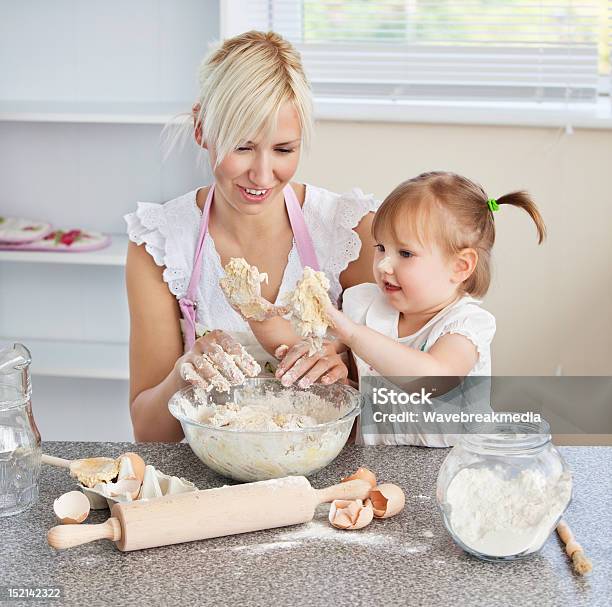 Simper Woman Baking Cookies With Her Daughter Stock Photo - Download Image Now - Adult, Apron, Baking