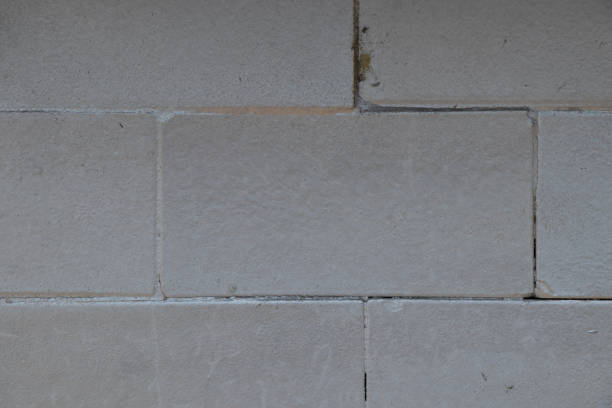 istock gray brick wall of a house painted with paint as a background 1521428683