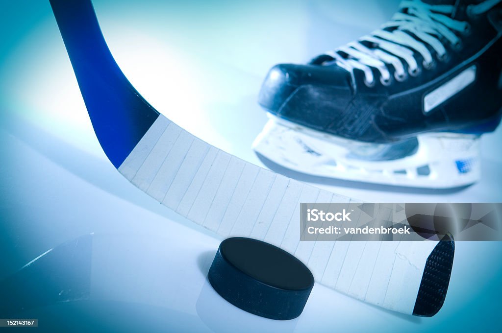 Blue tinted image of a hockey puck stick and ice skate Ice Hockey Ice Hockey Stock Photo