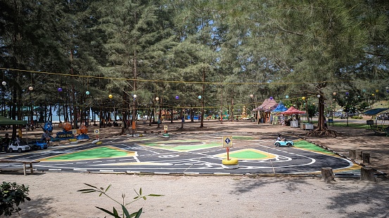 Bangka Belitung , Indonesia - 29 June 2023 : A public playground for children, an exciting weekend taking the children away to play with cars in the park