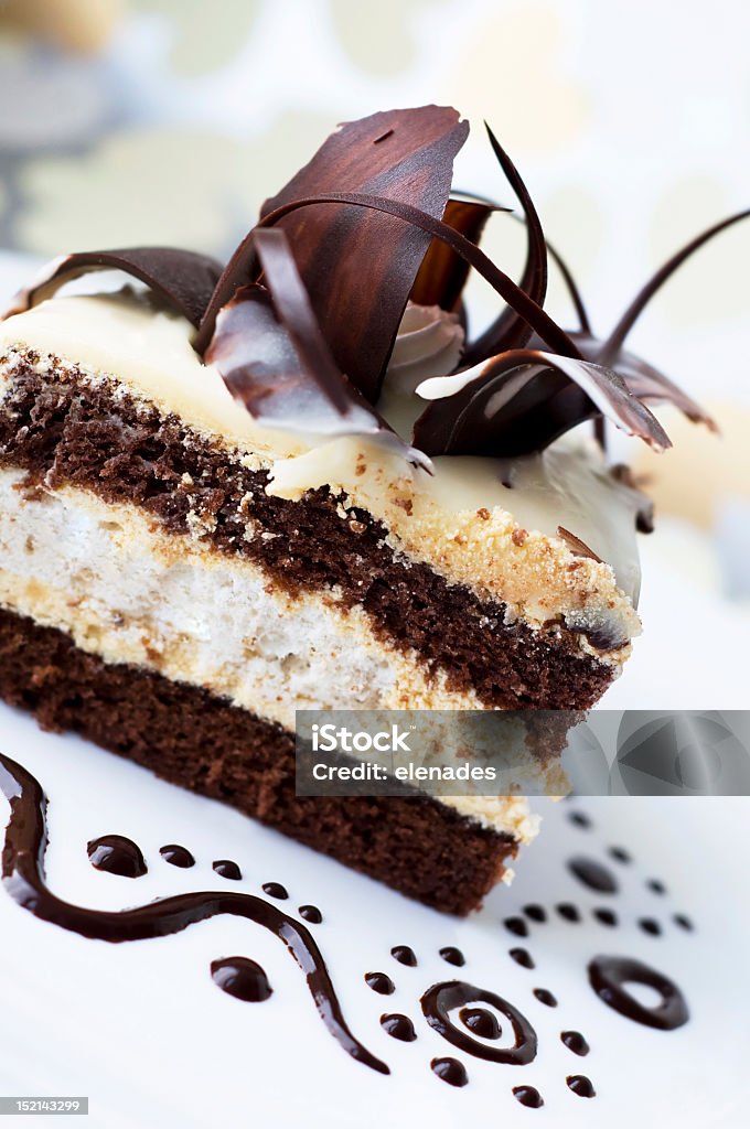 Cake with black and white chocolate Sweet appetizing cake with decorative chocolaty rose and chocolaty drops around the cake on cute gentle background with heart shapes. Sweet gentle photo. Baked Pastry Item Stock Photo