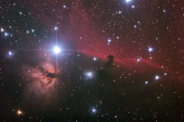 "The Horsehead Nebula is a dark dusty nebula seen over red glowing hydrogen clouds behind in the Orion constellation. Brightest star on the image is Alnitak, the star farthest left on Orion's Belt. Flame Nebula also called ""Flaming Tree"" is just below this star. These nebulas are parts of the Orion Molecular Cloud Complex, a star-forming region in our Milky Way Galaxy.    "