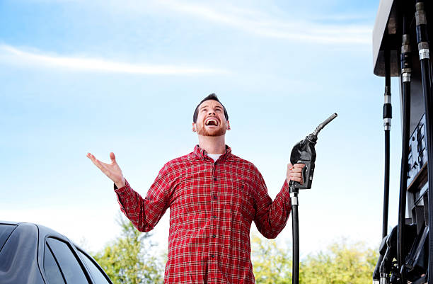 Man at gas pump completely frustrated with the increased prices