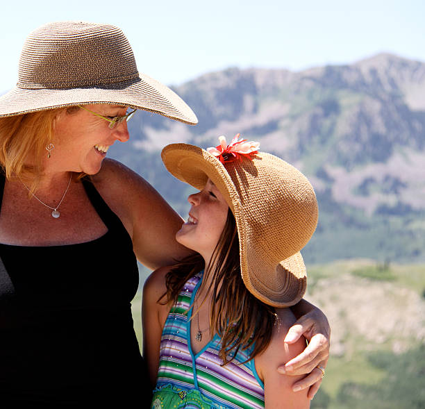 mother and daughter in mountains stock photo