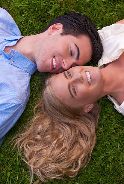 istock Beautiful young couple touching cheeks in grass 152146250