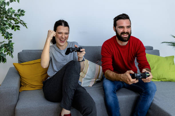 istock A beautiful young woman is playing computer games with her boyfriend. 1521464671