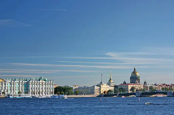 Saint-Petersburg. View of the Palace quay (Winter Palace - Hermitage, Admiralty, St. Isaac's Cathedral, Palace Bridge, Neva). Weather sunny.