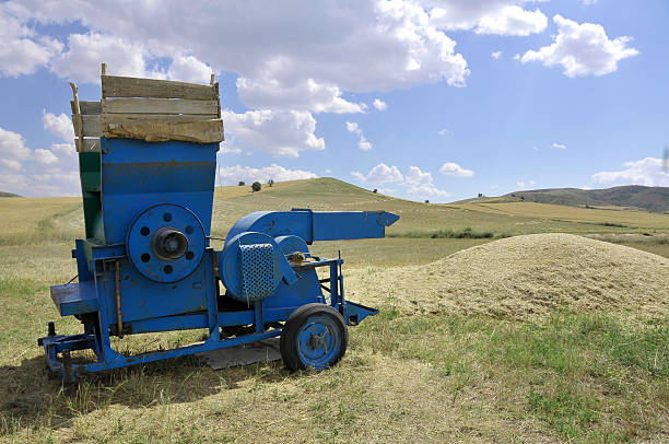 Threshing Field An old treshing machine in the treshing field. threshing stock pictures, royalty-free photos & images