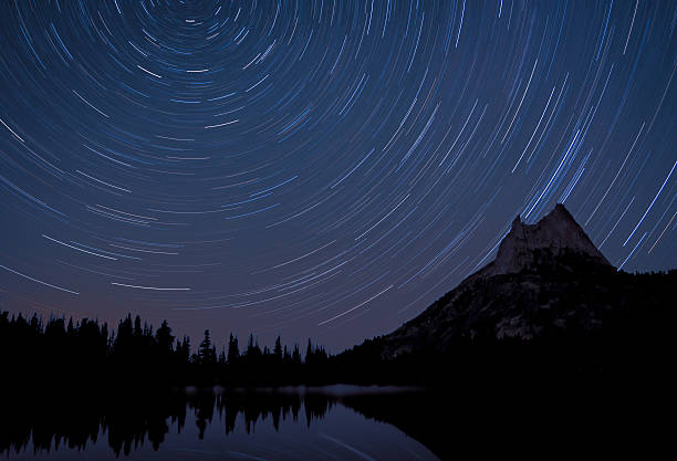 Star Trails and Cathedral Peak Reflected in Upper Lake stock photo