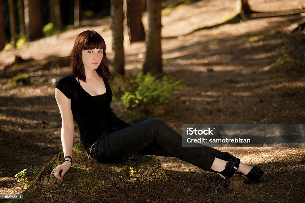 Cute teenage girl resting in forest Cute teenage girl resting in a shadow of forest. Adolescence Stock Photo