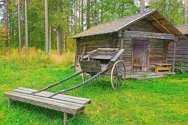 istock Old wooden cart in front of log barn 152149686