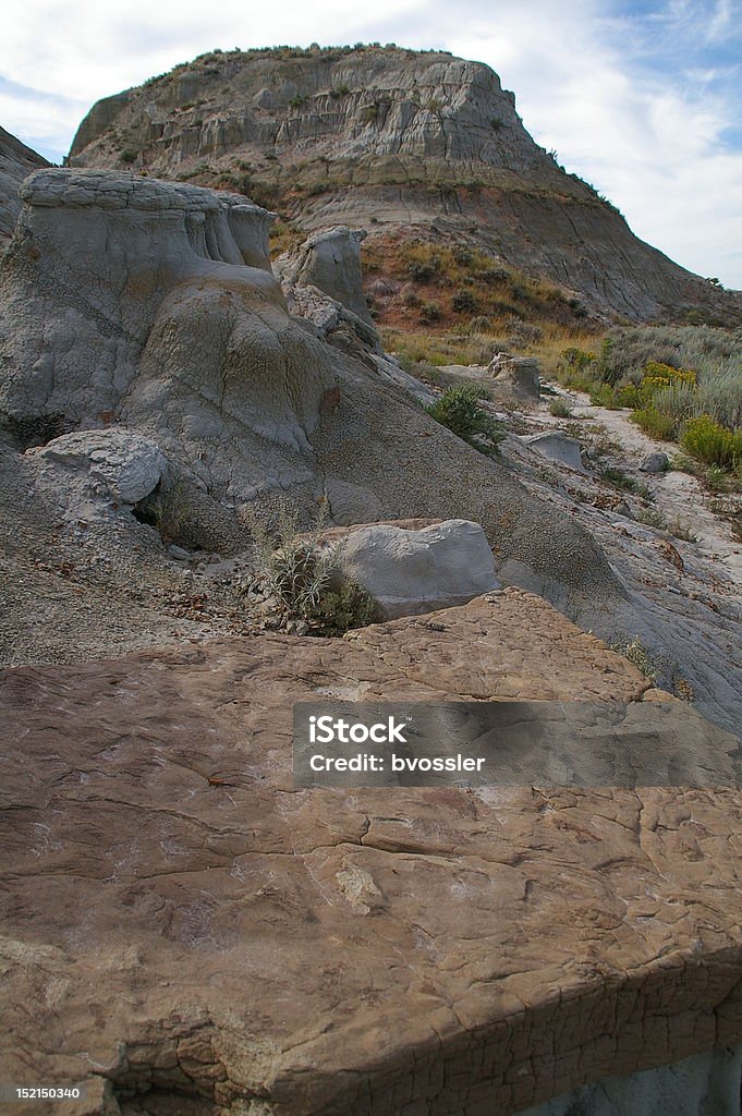 Badlands View of Rock Formations Rocks litter the ground in front of a butte in the North Dakota Badlands. Badlands Stock Photo