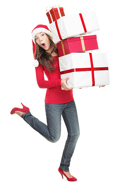 sorpresa donna in santa cappello in esecuzione con regali - holiday emotional stress christmas santa claus foto e immagini stock