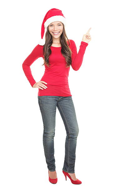 istock Christmas woman pointing at copy space standing 152151798