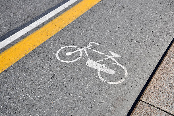 White bicycle sign painted on a street stock photo