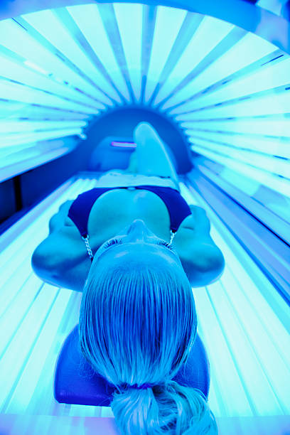solarium treatment young woman at laying on solarium bed and get brown skin tone ready for summer tanning bed stock pictures, royalty-free photos & images