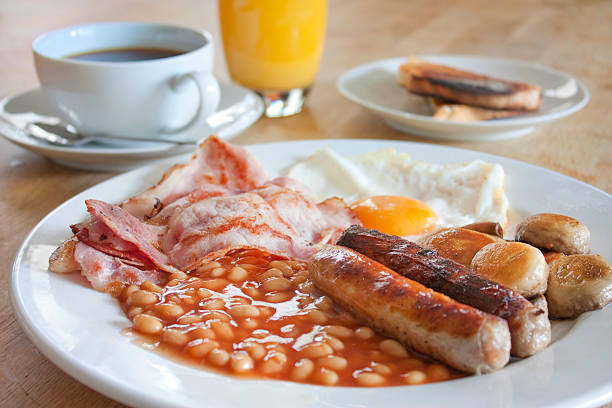 cooked breakfast on a wooden table stock photo