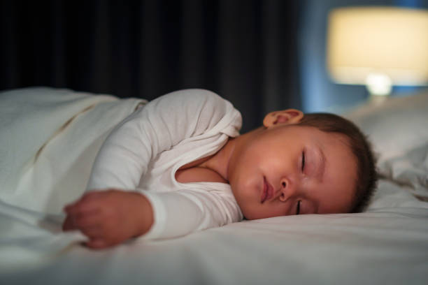 istock infant baby sleeping on bed at night 1521527268