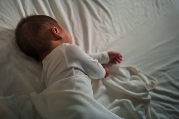 istock infant baby sleeping on bed at night 1521527270