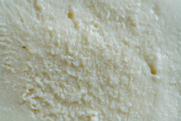 istock Sliced white mozzarella buffalo cheese for background, closeup. White pulp texture of mozzarella cheese 1521533505