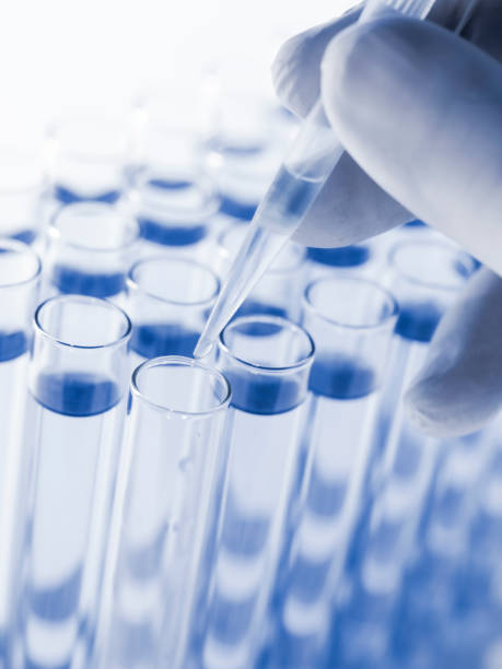 istock Droplet Falling from Pipette into Test Tube. 1521535065