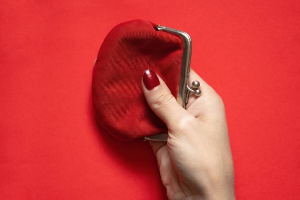 istock red old wallet and female hand on isolated background close-up 1521541722