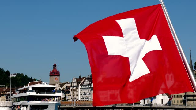 Swiss Flag in City of Lucerne and Passenger Ship in a Sunny Summer Day in Lucerne