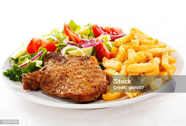 Grilled Pork Chop With Chips And Vegetables Stock Photo - Download Image Now - Color Image, Cucumber, Dining