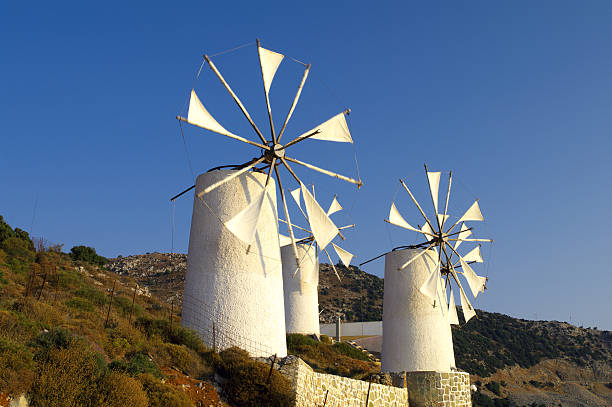 istock Traditional white painted windmills on a hill in Greece 152157332