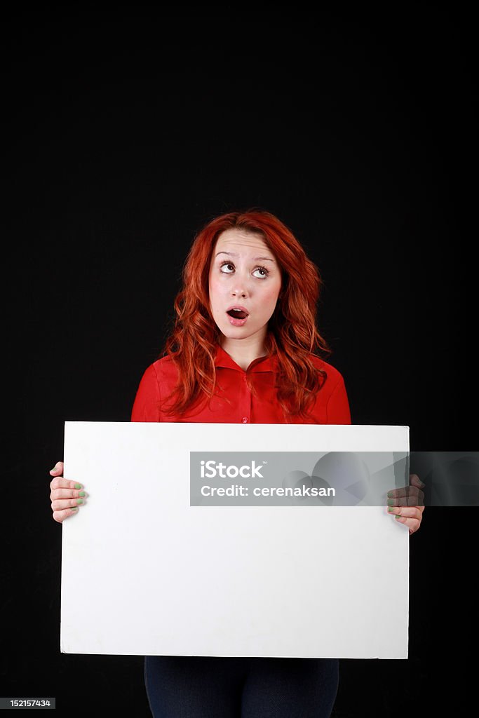 thinking redhead holding pancarte thinking redhead with holding empty pancarte Adult Stock Photo