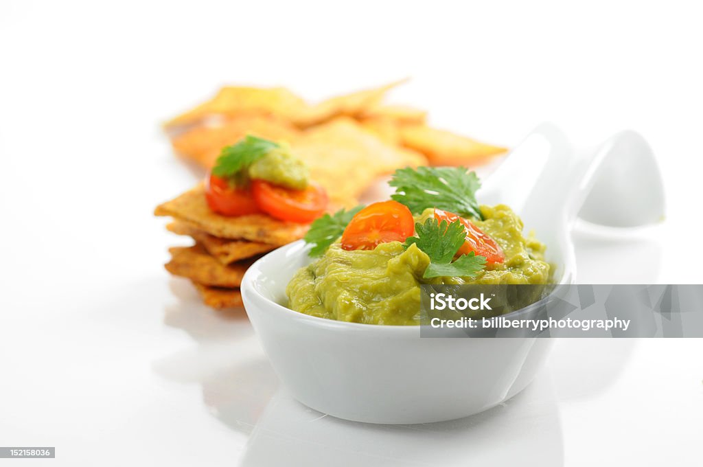 Guacamole Fresh homemade guacamole served with backed chips. Bowl Stock Photo