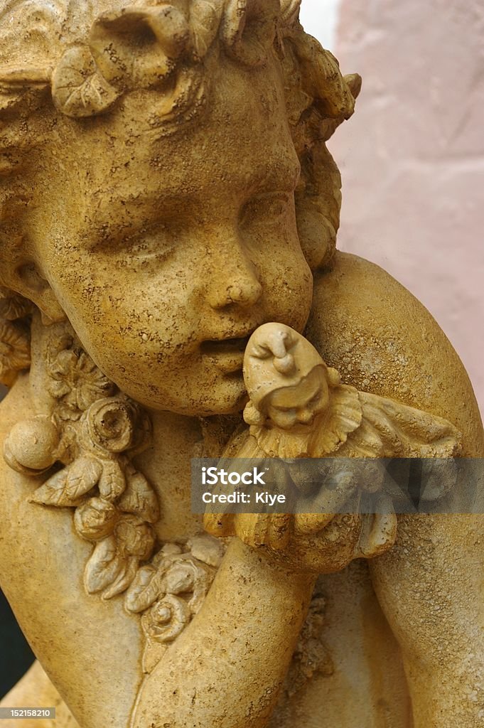 Cherub statue Unique cherub statue with a smaller statue held to its face. Very cute. Angel Stock Photo