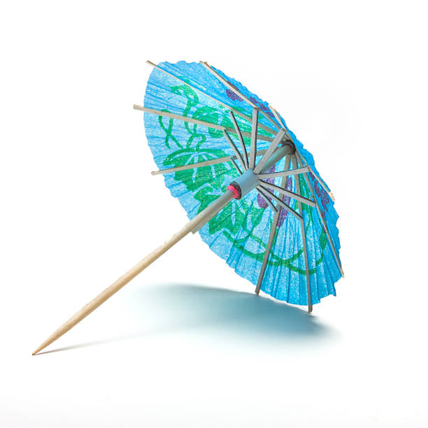 Cocktail Umbrella Cocktail Umbrella from low perspective isolated against white background. drink umbrella stock pictures, royalty-free photos & images