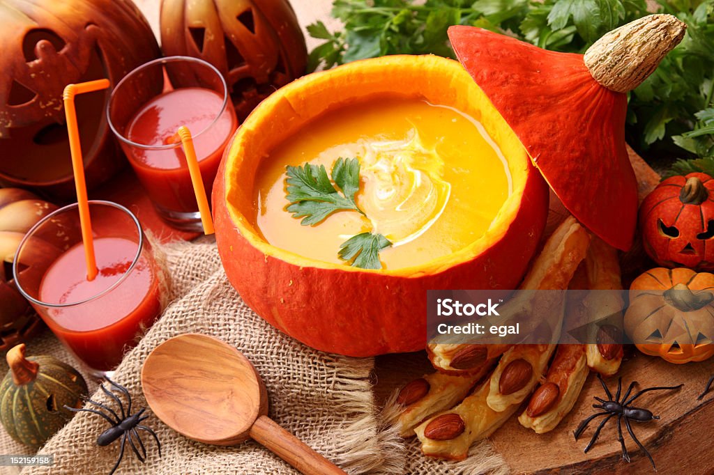 Pumpkin soup contained within a hollowed pumpkin Pumpkin  soup for halloween party Halloween Stock Photo