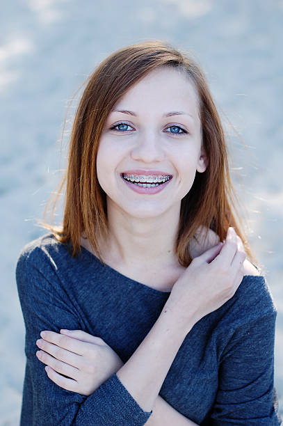 istock Girl with braces smiling cheerfully 152159802