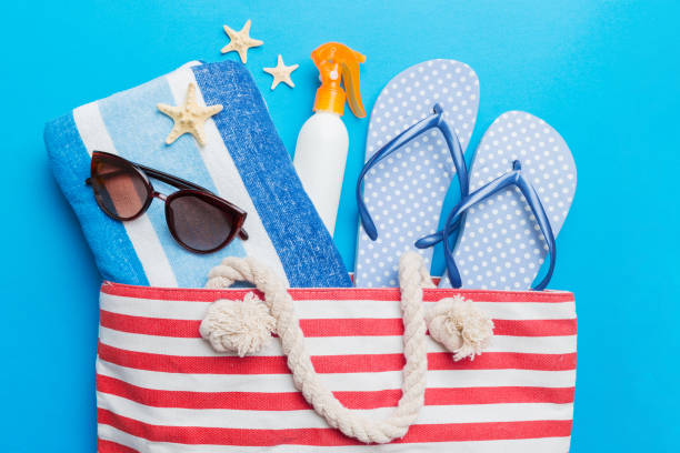 istock beach accessories flat lay top view on colored background Summer travel concept. Bag with starfish and sea shell. Top view 1521601950