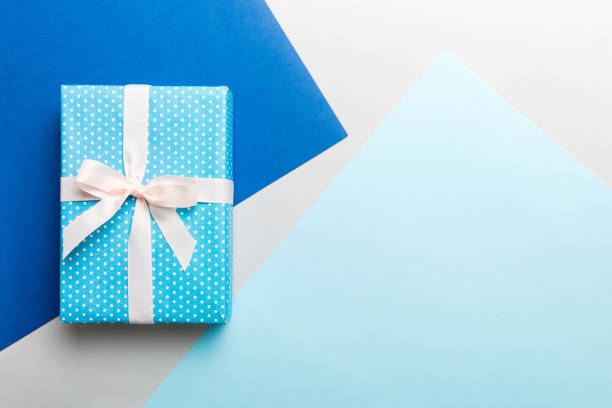 istock holiday handmade paper present tied white ribbon bow top view with copy space. Flat lay holiday background. Birthday or christmas present. Christmas gift box concept with copy space 1521602811