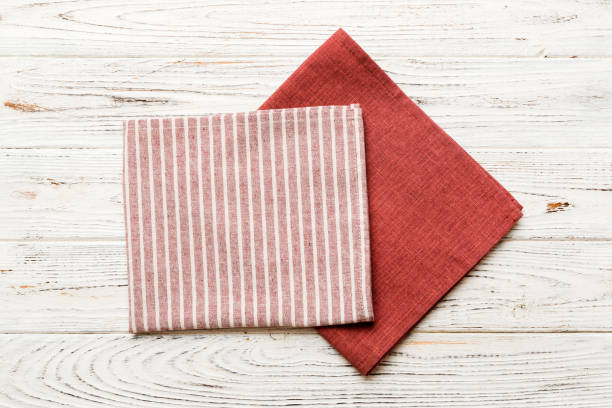 istock top view with red empty kitchen napkin isolated on table background. Folded cloth for mockup with copy space, Flat lay. Minimal style 1521603547