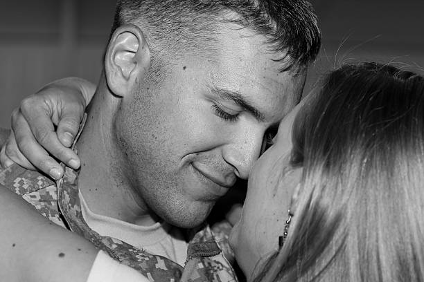 A soldier happy to be reunited with his wife stock photo