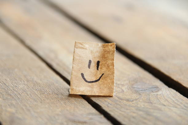 istock Smiley face on wooden background, copy space. 1521613198