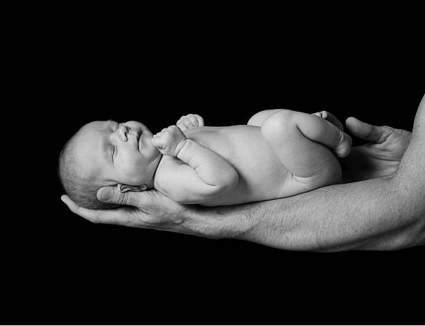 istock New born Baby sleeping on male forearm 152162761