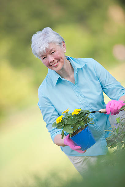 istock Senior Lady Planting Flowers 152163394