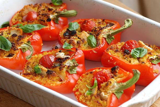 Roasted red peppers filled with couscous stock photo