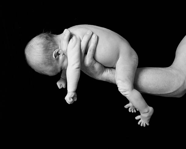 istock new born baby held in fathers hand 152164028