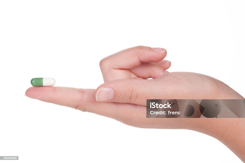 Grünen medizinische Kapsel in eine weibliche hand, isoliert - Lizenzfrei Abnehmen Stock-Foto